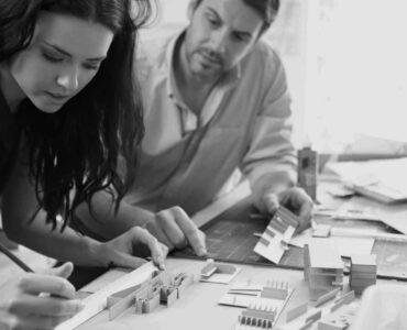 Two Architects Making Models In Office Together