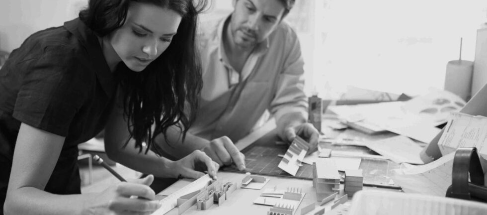 Two Architects Making Models In Office Together